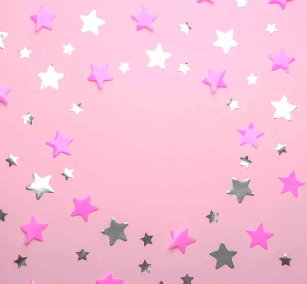 Frame made of confetti stars with space for text on pink background, top view. Christmas celebration — Stock Photo, Image