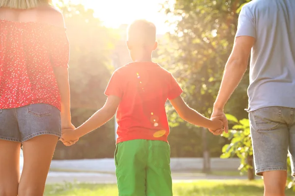 Little boy and his parents holding hands outdoors. Family weekend — Stock Photo, Image