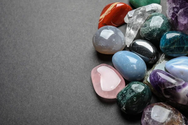 Flat lay composition with different gemstones on dark table, space for text — Stock Photo, Image