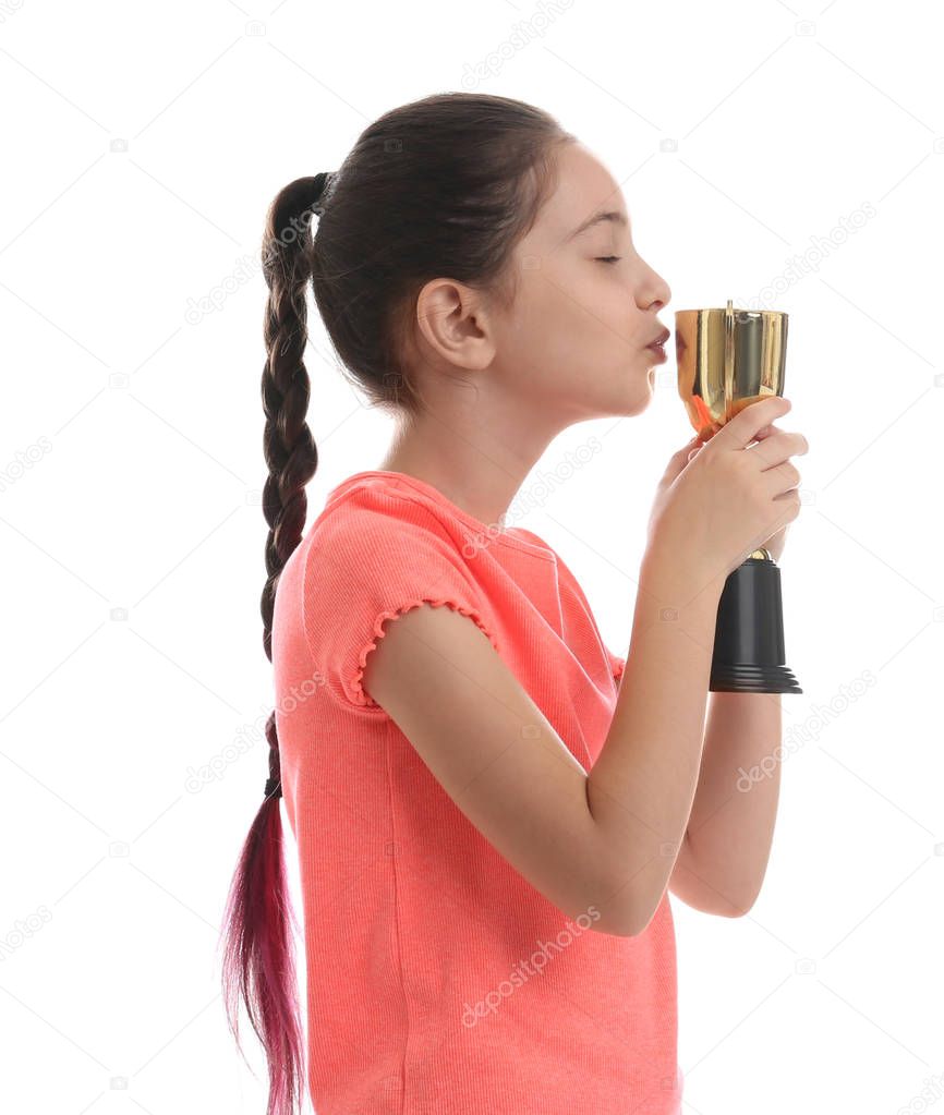 Happy girl kissing golden winning cup isolated on white