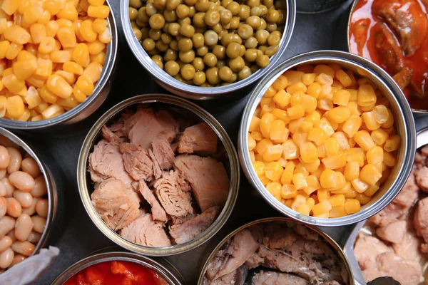 Open tin cans of conserved products, top view — Stock Photo, Image