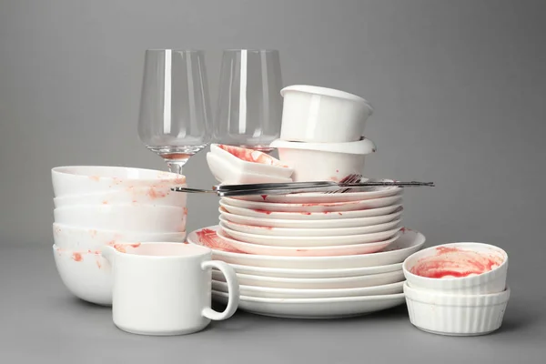 Set of dirty dishes on grey background — Stock Photo, Image