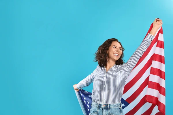 Happy young woman with USA flag on blue background. Space for text — Stock Photo, Image