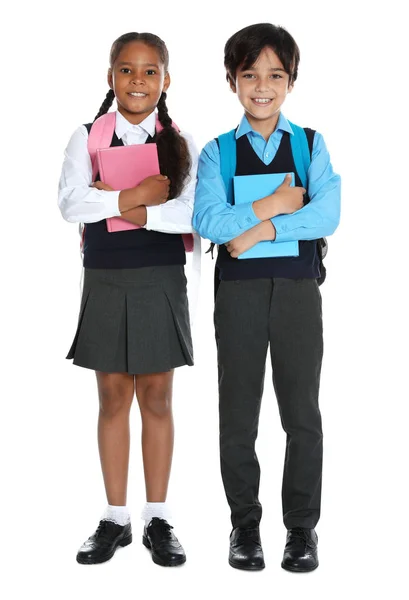 Niños felices en uniforme escolar sobre fondo blanco —  Fotos de Stock