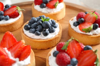 Farklı berry tartile ahşap tabak. Lezzetli hamur işleri