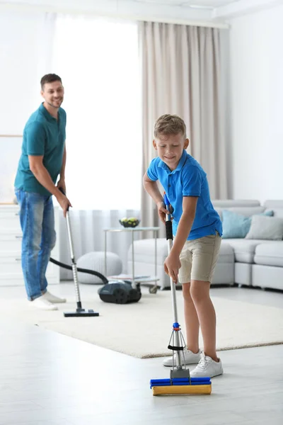 Dad and son cleaning living room together — Stock Photo, Image