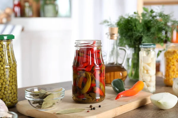 Jar with pickled chili peppers on wooden table indoors — Stock Photo, Image