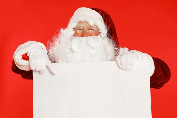 Autêntico Papai Noel com banner em branco no fundo vermelho. Espaço para design — Fotografia de Stock