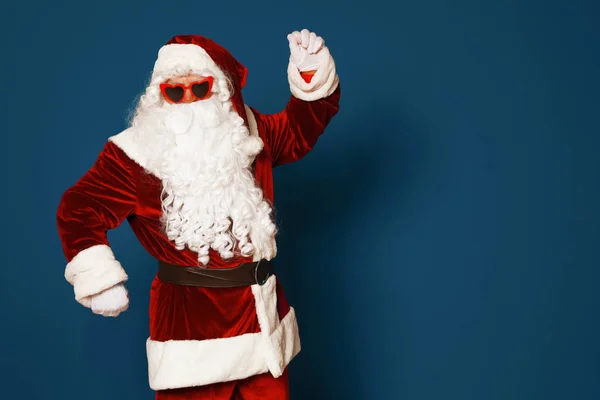 Auténtico Santa Claus con gafas de sol sobre fondo azul. Espacio para texto —  Fotos de Stock