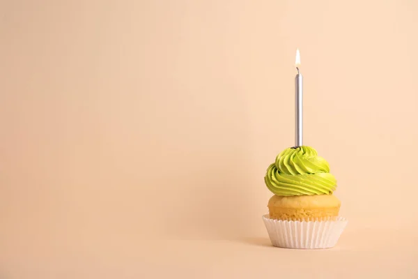 Cupcake d'anniversaire avec bougie sur fond beige, espace pour le texte — Photo