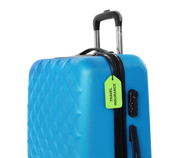 Blauer Koffer mit Reiseversicherungsetikett auf weißem Hintergrund — Stockfoto