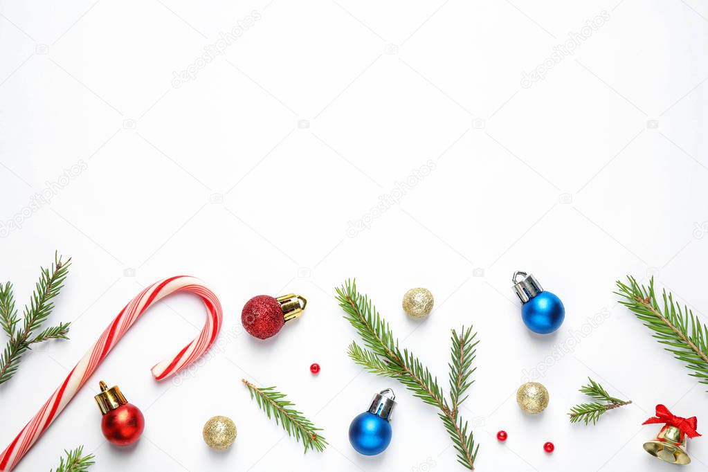 Flat lay composition with Christmas tree branches and festive decor on white background. Space for text