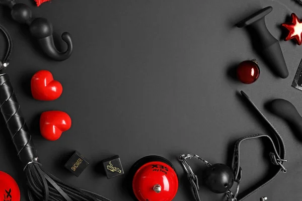 Frame made with different sex toys and Christmas balls on black background, flat lay. Space for text — Stock Photo, Image