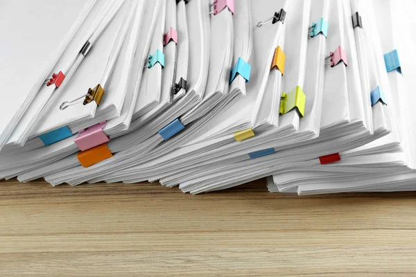 Stack of documents with binder clips on wooden table, closeup view — Stock Photo, Image