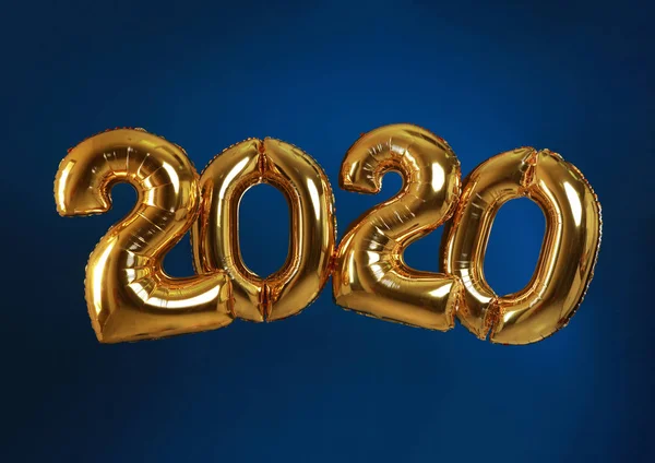 Golden balloons for party decoration on blue background. 2020 New Year celebration