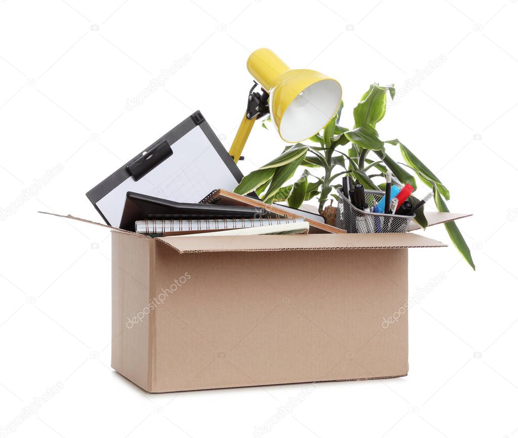 Cardboard box full of office stuff on white background