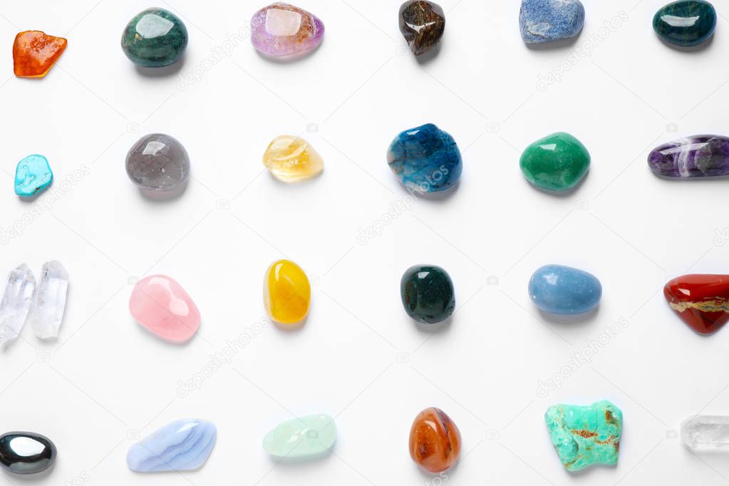 Different gemstones on white background, top view
