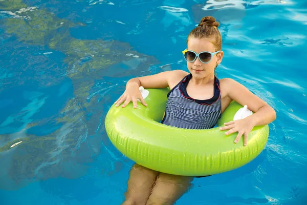 Niña feliz con anillo inflable en la piscina —  Fotos de Stock