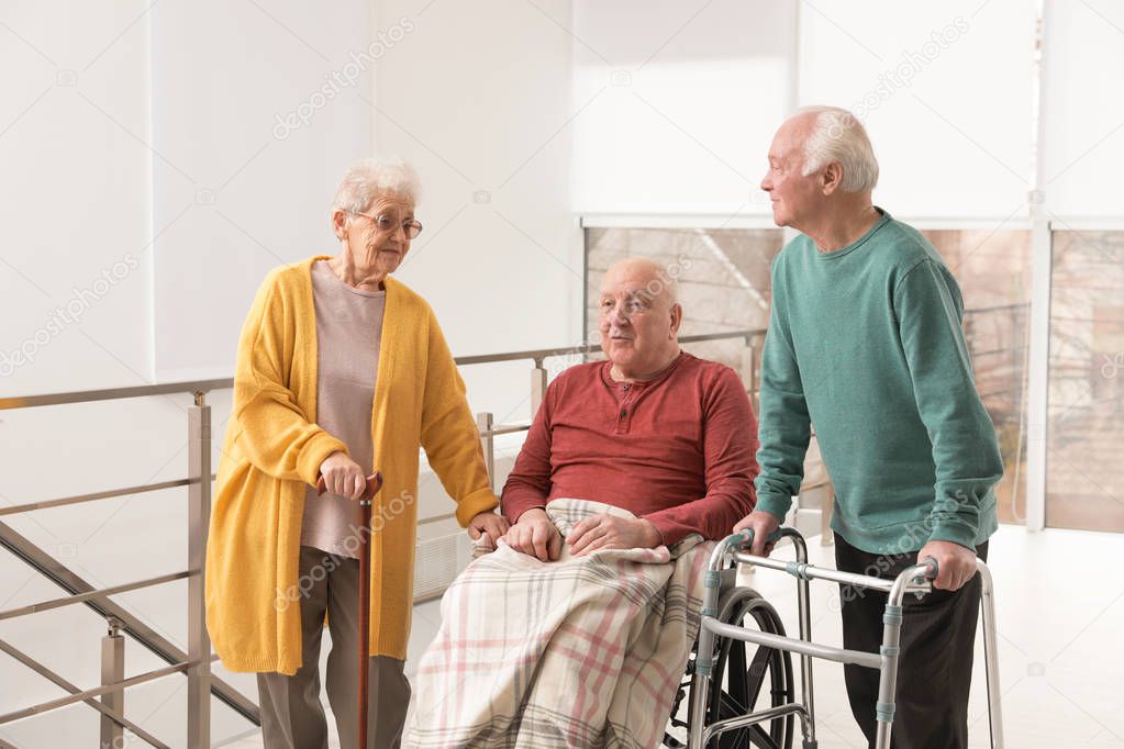 Group of happy senior people in hospital