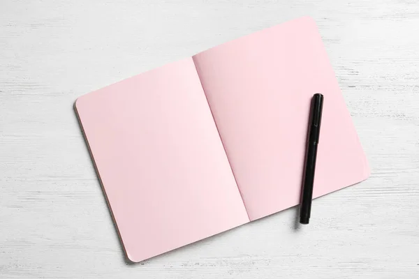 Notebook and marker on white wooden background, space for text. Sex education — Stock Photo, Image