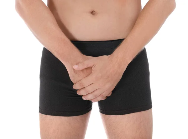 Člověk trpící bolestí na bílém pozadí, v šatně. Urologické problémy — Stock fotografie