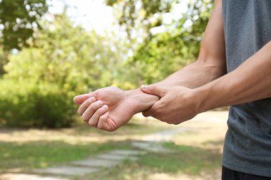 Genç adam açık havada eğitim den sonra nabız kontrol, closeup