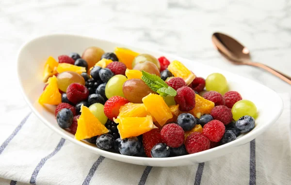 Fresh tasty fruit salad on table, closeup — Stock Photo, Image