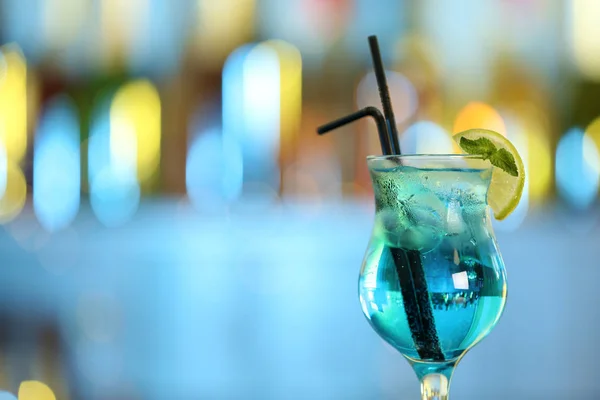 Glass of fresh alcoholic cocktail against blurred background. Space for text Stock Image