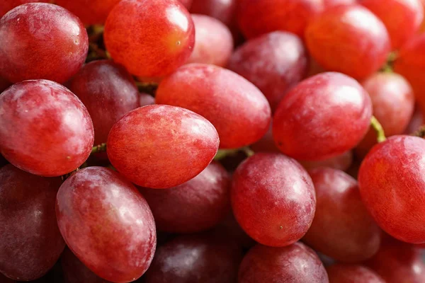Fresh ripe juicy pink grapes as background, closeup view — Stock Photo, Image