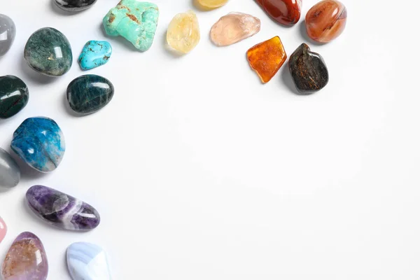 Different beautiful gemstones on white background, top view — Stock Photo, Image