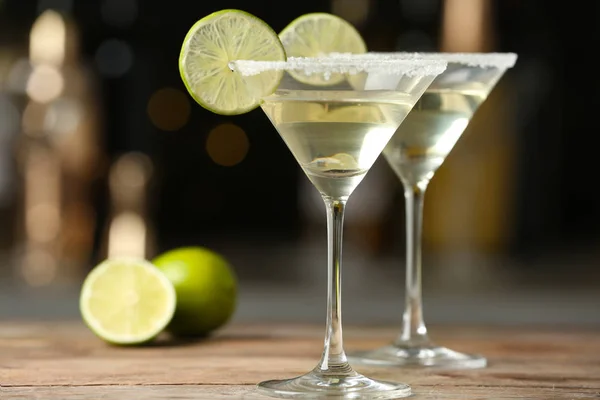 Copas de Lime Drop Martini cóctel sobre mesa de madera sobre fondo borroso — Foto de Stock