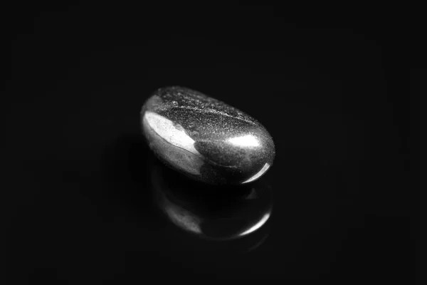 Beautiful shiny hematite gemstone on black background — Stock Photo, Image