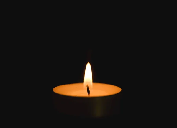 Bright burning candle in darkness. Funeral symbol — Stock Photo, Image