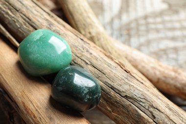 Beautiful green aventurin and heliotrope gemstones with wooden sticks clipart