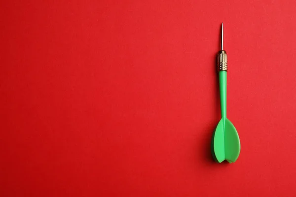 Green dart arrow on red background, top view with space for text