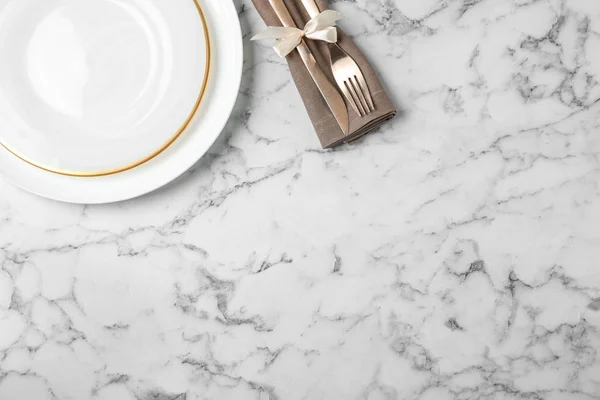 Beautiful table setting on white marble background, flat lay. Space for text — Stock Photo, Image