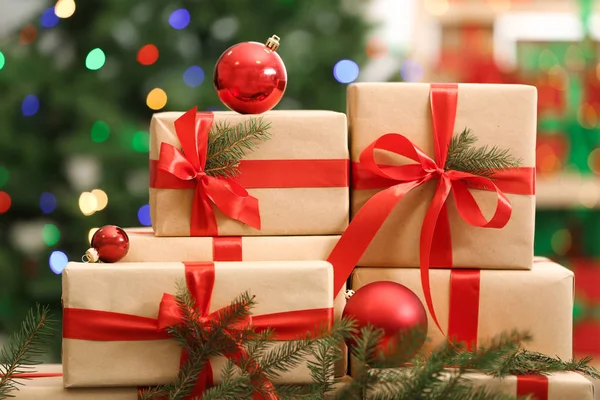 Many Christmas gifts on table against blurred background