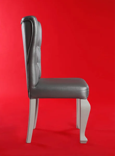 Stylish silver chair on red background. Element of interior design — Stock Photo, Image