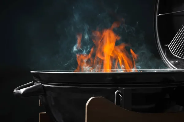 Nova churrasqueira moderna com fogo no fundo escuro — Fotografia de Stock