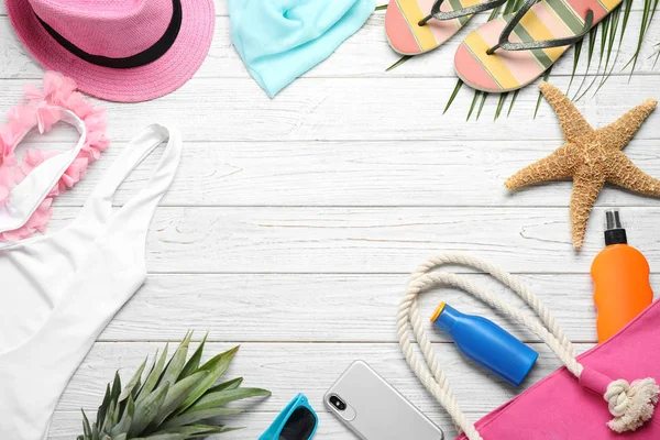 Flat lay composition with beach accessories on white wooden background, space for text — Stock Photo, Image