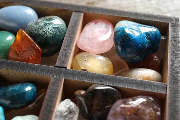 Box with different beautiful gemstones on table, closeup — Stock Photo, Image