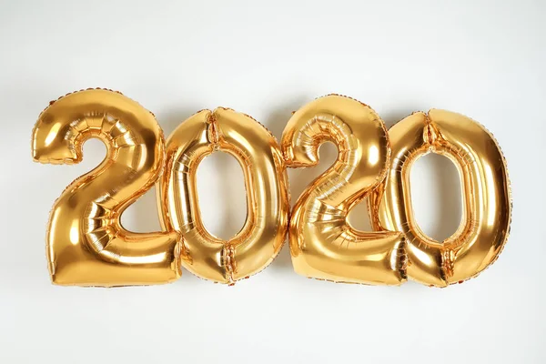 Golden balloons for party decoration on white background. 2020 New Year celebration