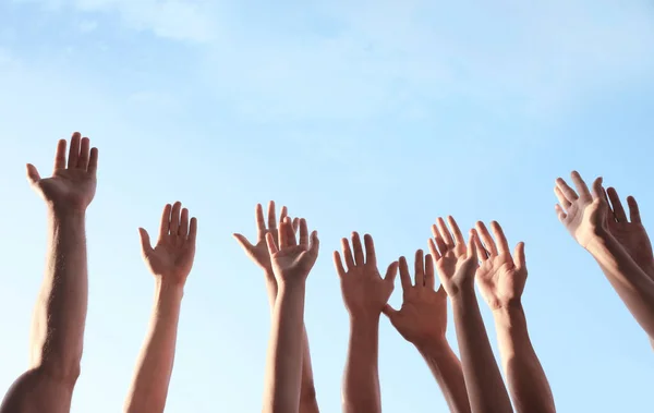 Group of volunteers raising hands outdoors, closeup — Stock Photo, Image