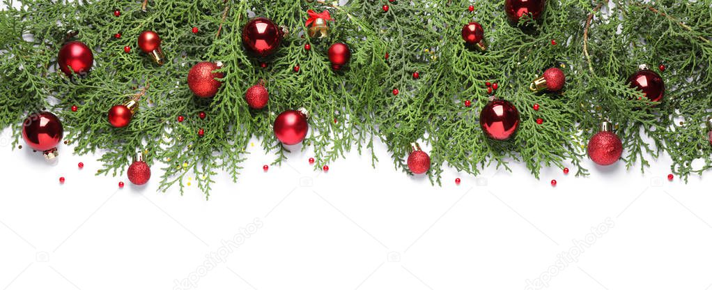 Thuja branches with Christmas decorations on white background, flat lay