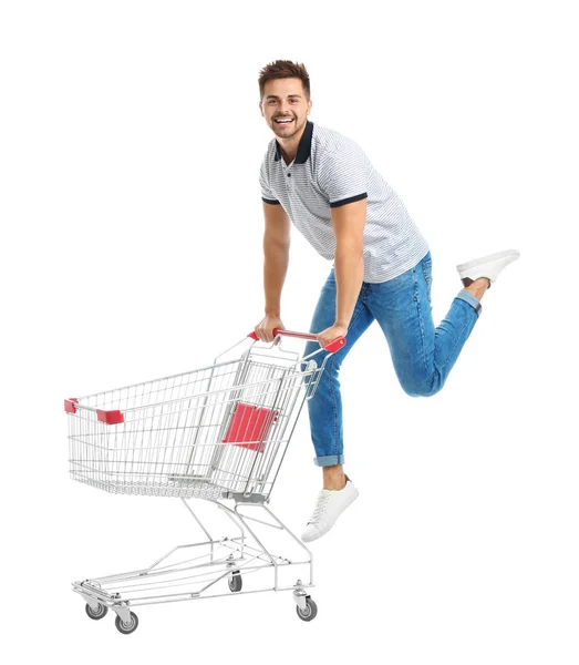 白い背景に空のショッピングカートを持つ若い男 — ストック写真