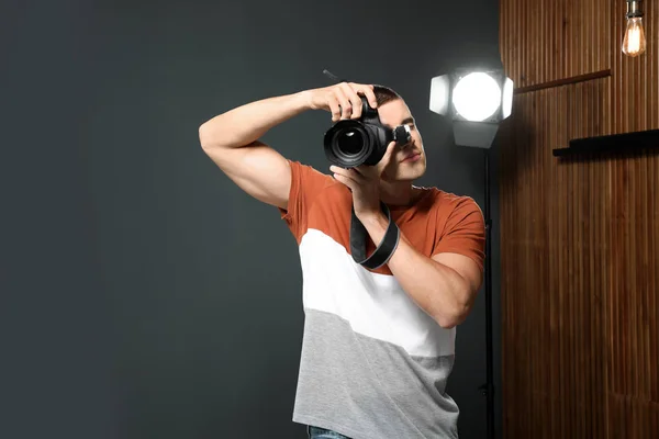 Professional photographer taking picture in modern studio — Stock Photo, Image