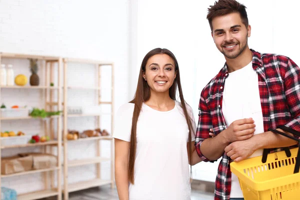 Jeune couple avec panier dans l'épicerie — Photo