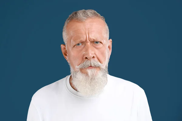 Portrait of handsome senior man on blue background — Stock Photo, Image