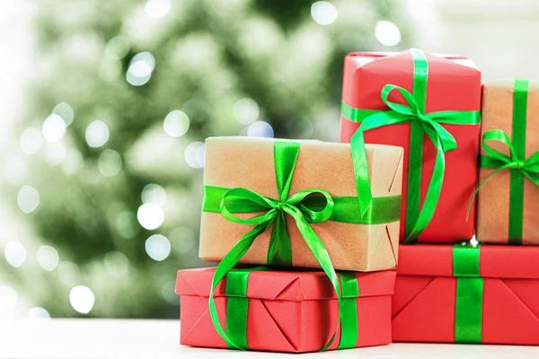 Christmas gifts on table against blurred background. Space for text — Stock Photo, Image