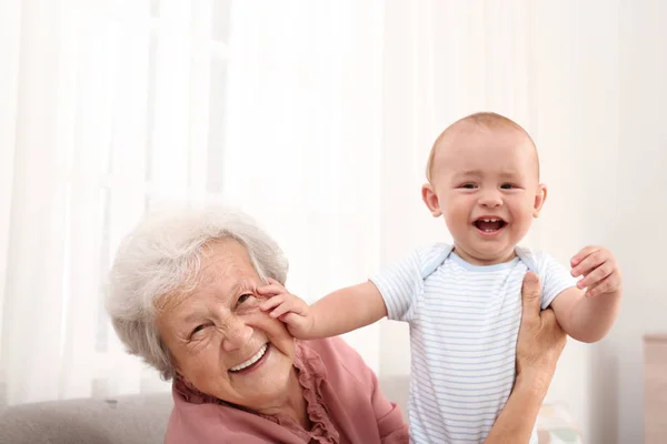 Happy grandmother with little baby at home — Stock Photo, Image